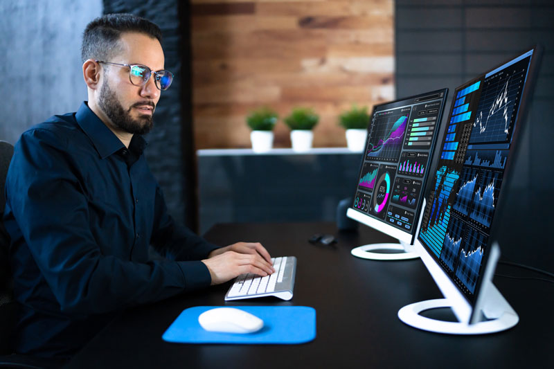 man reviewing analytics on a computer screen