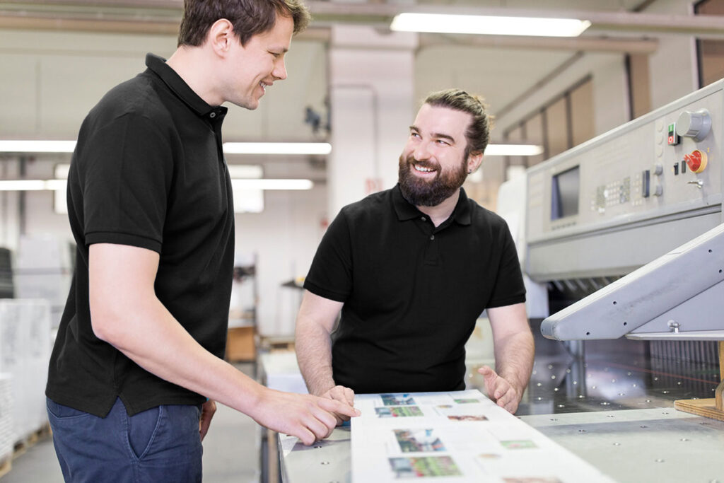 two men working on printer